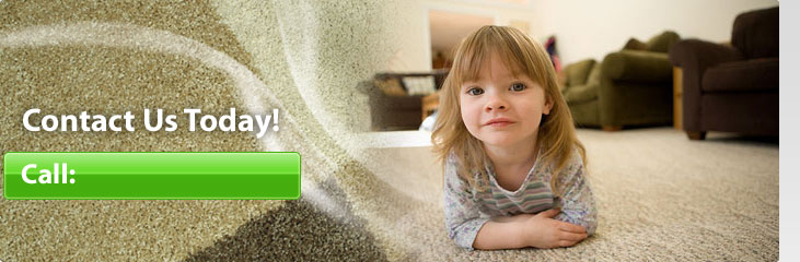 Little girl lying on a carpet in living room